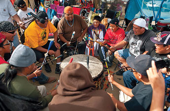 The Holy Smokes group from Sand Springs perform dring the end of the afternoon at the powwow in Littlewater Saturday. © 2011 Gallup Independent / Diego James Robles
